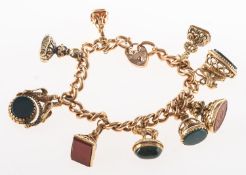 An early 20th century 9ct gold charm bracelet with nine fob seals,