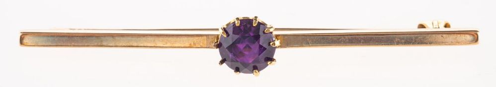 An amethyst bar brooch, claw set to the centre with a circular-cut amethyst,
