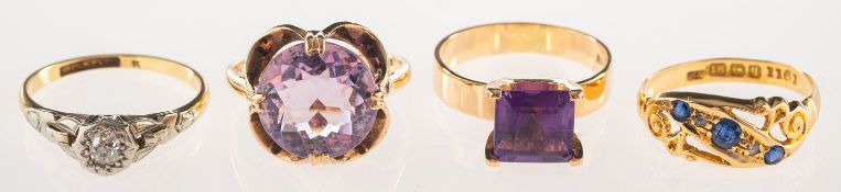 A group of four rings, including an 18ct gold ring of openwork scroll design,