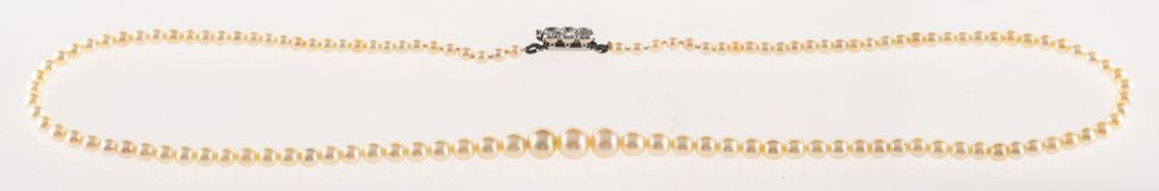 Garrard & Co. A pearl and diamond necklace, a string of graduated pearls, measuring approx. 2.