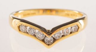 An 18ct gold diamond wishbone ring, channel set with seven brilliant-cut diamonds, diamonds approx.