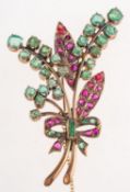 An antique emerald and ruby brooch, of leaf spray and bow form, claw,