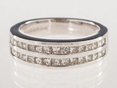 An 18ct white gold princess-cut diamond ring, channel set with two rows of princess-cut diamonds,