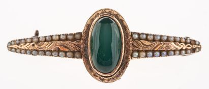 An antique bar brooch, collet set to the centre with an elongated oval green stone cabochon,
