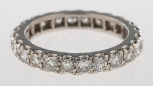 A full diamond eternity ring, set with twenty-four brilliant-cut diamonds in a scallop setting,