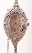 A gold and white metal diamond set lady's cocktail watch the cushion-shaped silvered dial having