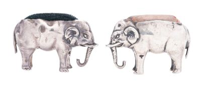 Two early 20th century novelty silver pin cushions, in the form of elephants, with material linings,