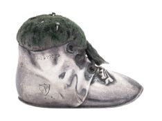 A George V silver pin cushion, in the form of a lace-up boot and with green material,