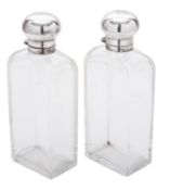 A George V cased pair of silver mounted clear glass bottles,