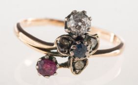 A diamond, ruby and sapphire ring, of floral and foliate form, claw set with an old-cut diamond,