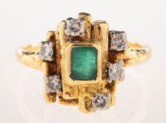 A 1970's 18ct gold emerald and diamond ring, of abstract design with a textured finish,