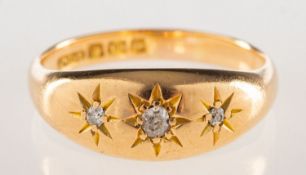 An 18ct gold diamond gypsy ring, star set with an old-cut diamond and two single-cut diamonds,