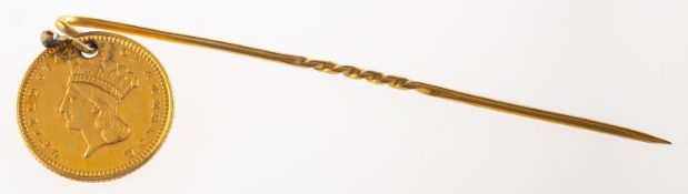 A stick pin with attached one dollar coin,