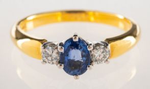 An 18ct gold sapphire and diamond three stone ring,