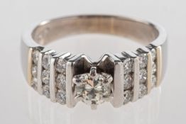 A multi-stone diamond ring, claw set to the centre with an older-cut diamond, diamond approx. 0.