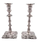 A pair of Victorian silver candlesticks, on shaped square bases, with knopped stems,
