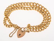 A double curb bracelet with heart padlock and safety chain,