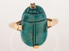 A scarab beetle ring, claw set with a carved blue scarab beetle,