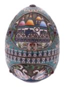 An early 20th century Russian silver & enamel egg, with corded borders & cabachon-set stones,