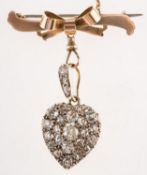 An antique diamond heart pendant with bow brooch attachment,