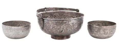 A Far-Eastern swing-handled white metal bowl, circular form,