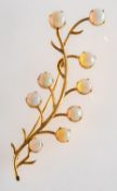 An opal leaf spray brooch, claw set with nine circular-cut opal cabochons,