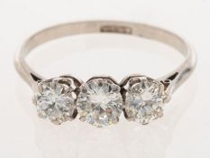 A three stone diamond ring, set with three older brilliant-cut diamonds, (transitional-cut?),
