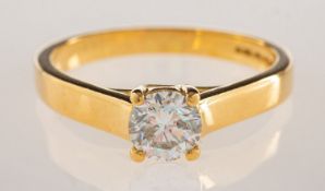 An 18ct gold 0.50 carat diamond solitaire ring, claw set in a classic 'Tiffany' crossover setting