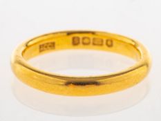 A 22ct gold wedding band, UK hallmark, size M1/2, 5.1grams.