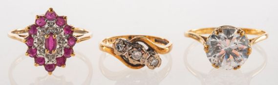 A group of three 9ct gold rings, including a 9ct gold three stone ring,