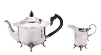 An Edwardian silver tea pot & matching milk jug, circular form, with wavy rims,