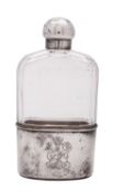 A Victorian silver mounted clear glass spirit flask, shaped oval, with a faceted upper body,