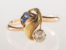 A diamond and sapphire ring, the ring of foliate form with a textured and polished finish,