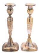 A pair of 20th century silver candlesticks, of rounded square form,