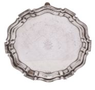 An Edwardian silver salver, of shaped circular outline, with a moulded border,