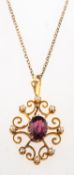 An Edwardian garnet and pearl pendant with chain, the pendant of ornate openwork design,