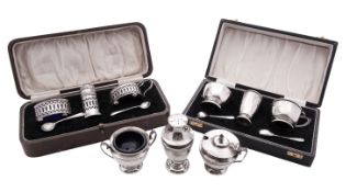 Two 20th century cased three-piece silver condiment sets, one set with pierced bodies,