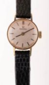 Omega a lady's 9K gold wristwatch the matted round silvered dial having raised baton numerals,