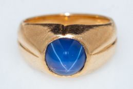 A star sapphire ring, a signet style ring, rub-over set with star sapphire cabochon,