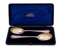 An Edwardian cased pair of fruit serving spoons, in a decorative pattern,