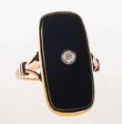 An Art Deco plaque ring, collet and milgrain set with a rectangular black plaque, (possibly onyx),