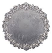 A Victorian silver salver, of shaped circular outline, with a husk & scroll border,