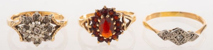 A group of three rings, including a 9ct gold cluster ring,