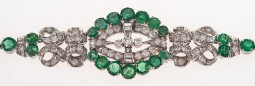 An emerald and diamond bracelet, possibly Art Deco, of geometric and ribbon design,