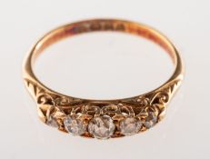 An early 20th century 18ct gold diamond ring, claw set with five graduated old-cut diamonds,
