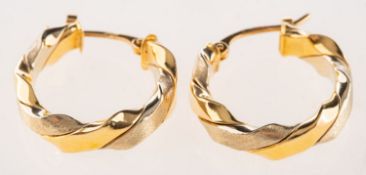 A pair of bi-colour twist hoop earrings,