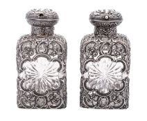 A pair of late Victorian silver mounted clear cut-glass toilet bottles,