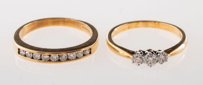 Two 18ct gold and diamond rings, including an 18ct gold three stone ring,
