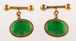 A pair of jade cufflink's, each set with an oval jade cabochon in a rope twist mount,