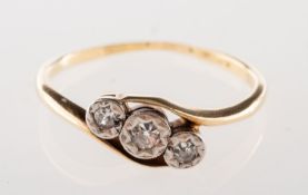 A three stone diamond twist ring, illusion set with three small single-cut diamonds,